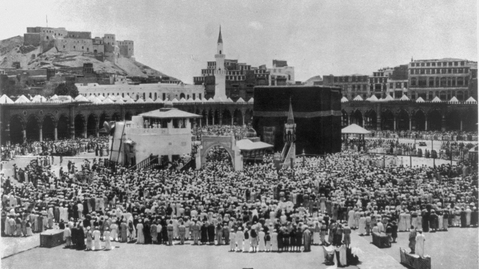 Rows of worshippers praying together around the Kaaba in the Sacred Mosque, Mecca